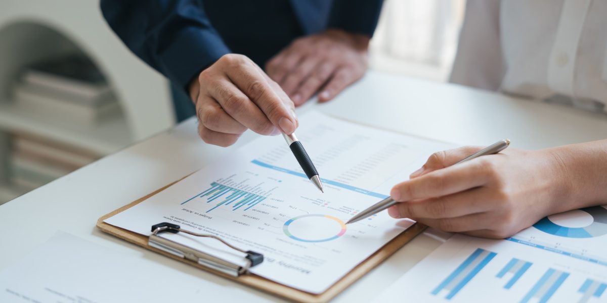 Business sales consultant discussing in data documents at modern office.