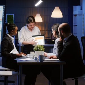Diverse multi-ethnic businesspeople analyzing management graphs using tablet