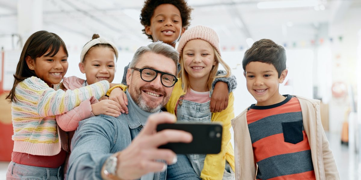 Selfie, children and teacher with smartphone, happy and smile for picture, excited and teacher. Kid